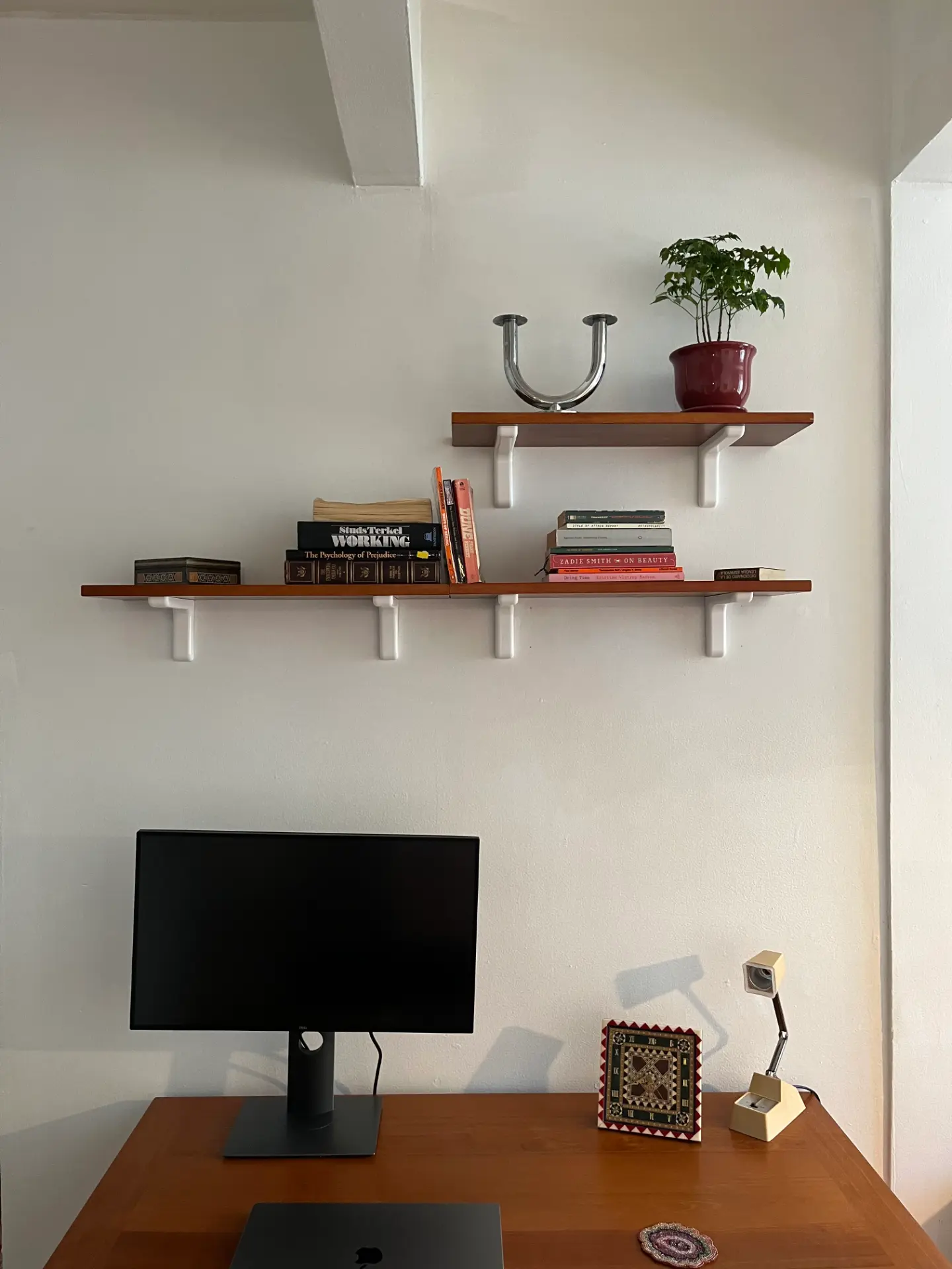 Custom office wall shelves installed over a desk